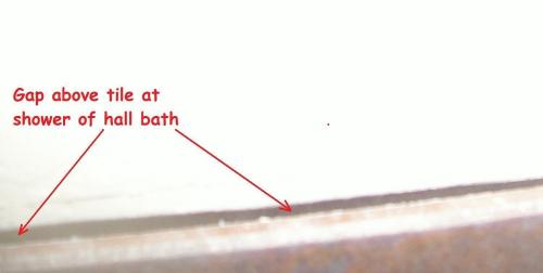 Large gap behind top of shower tile